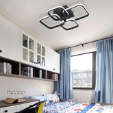 Modern bedroom with white cabinets, a bed, and blue curtains.